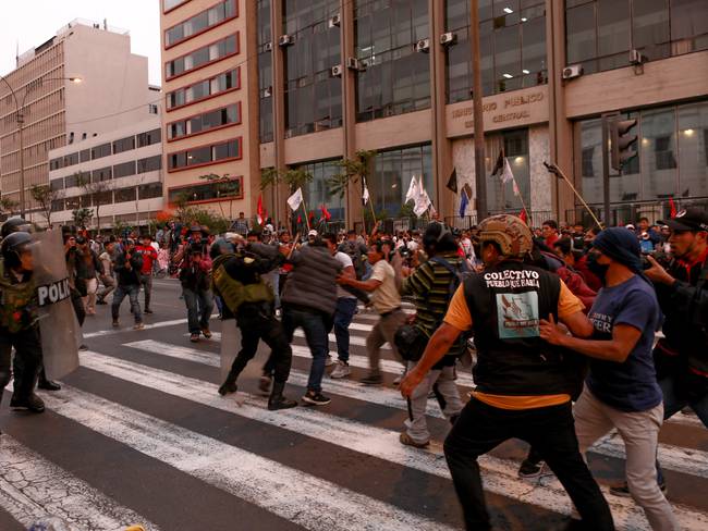 LIMA, PERU - Demonstrators clash with police during a protest demanding presidential elections, the release of Pedro Castillo and the closure of Congress after ousted Peruvian leader Pedro Castillo was detained in a police prison following his removal from office, in Lima, Peru, December 9, 2022 (Photo by Klebher Vasquez/Anadolu Agency via Getty Images)