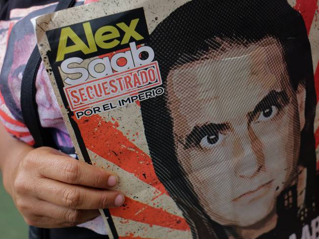 A woman holds a sign calling for the release of Alex Saab during a rally in support of the Colombian businessman who is being held in the United States, in the Petare neighborhood of Miranda Venezuela April 04, 2022  (Photo by Javier Campos/NurPhoto via Getty Images)