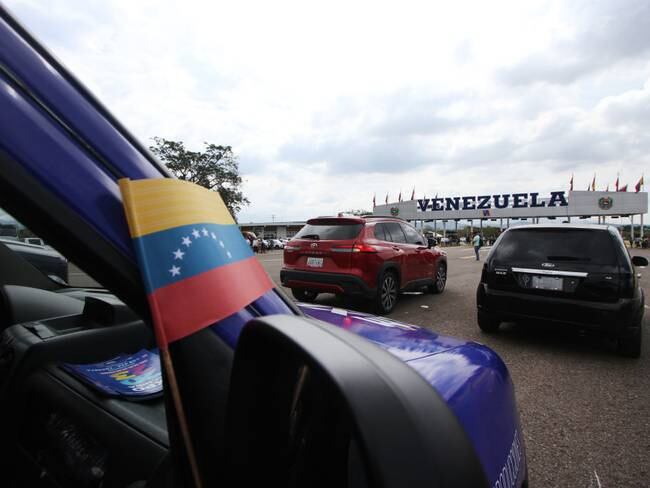 Vehicles are seen waiting to cross the border line during the opening of the international bridge Atanasio Girardot. Tienditas, January 01, 2023. Located between the border crossings of Colombia and Venezuela, the binational infrastructure, renamed the Atanasio Girardot Bridge, was the epicenter of the years of tensions that preceded the reestablishment of relations and will be reopened for the crossing of vehicles, as well as merchandise and people. 240 meters long and 40 meters wide, this bridge has lanes for cargo trucks, cars, pedestrians and bicycles.  (Photo by Jorge Mantilla/NurPhoto via Getty Images)