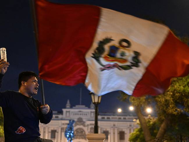 People take part in a demonstration demanding the closure of Congress in Lima, on December 10, 2022. (Photo by ERNESTO BENAVIDES / AFP) (Photo by ERNESTO BENAVIDES/AFP via Getty Images)