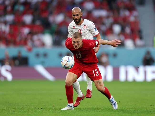 AL RAYYAN, QATAR - NOVEMBER 22: Rasmus Kristensen of Denmark controls the ball against Issam Jebali of Tunisia during the FIFA World Cup Qatar 2022 Group D match between Denmark and Tunisia at Education City Stadium on November 22, 2022 in Al Rayyan, Qatar. (Photo by Lars Baron/Getty Images)