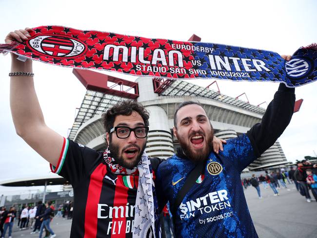 MILAN, ITALY - MAY 10: A fan of AC Milan and FC Internazionale pose for a photograph with a half and half scarf prior to the UEFA Champions League semi-final first leg match between AC Milan and FC Internazionale at San Siro on May 10, 2023 in Milan, Italy. (Photo by Alex Grimm/Getty Images)