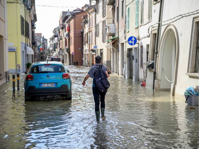 LUGO, ITALY - MAY 18: A woman walks on a flooded road during heavy rains caused flooding across Italy&#039;s northern Emilia Romagna region, on May 18, 2023 in Lugo, Italy. Nine people have died and thousands have been evacuated from their homes after torrential rain wreaked mayhem in the northern Italian region of Emilia-Romagna, causing severe flooding and landslides. (Photo by Antonio Masiello/Getty Images)