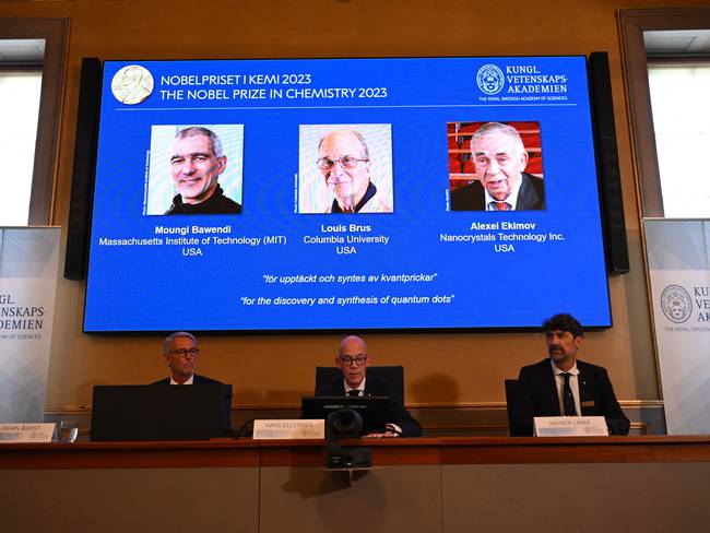 A screen shows this year&#039;s laureates US Chemist Moungi Bawendi, US Chemist Louis Brus and Russian physicist Alexei Ekimov during the announcement of the winners of the 2023 Nobel Prize in chemistry at Royal Swedish Academy of Sciences in Stockholm on October 4, 2023. The trio, whose names were leaked in the Swedish press ahead of the announcement, succeeded in producing these tiny components, that &quot;now spread their light from televisions and LED lamps, and can also guide surgeons when they remove tumour tissue, among many other things,&quot; the jury said. (Photo by Jonathan NACKSTRAND / AFP) (Photo by JONATHAN NACKSTRAND/AFP via Getty Images)