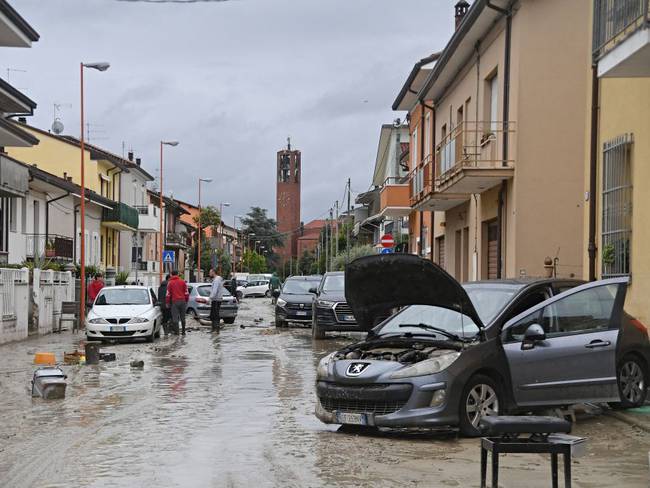 Local residents observe the aftermath of a flooding in a street of the San Rocco district of Cesena on May 17, 2023. Heavy rains have caused major floodings in central Italy, where trains were stopped and schools were closed in many towns while people were asked to leave the ground floors of their homes and to avoid going out. Five people have died after the floodings across Italy&#039;s northern Emilia Romagna region, a local official said. (Photo by Alessandro SERRANO / AFP) (Photo by ALESSANDRO SERRANO/AFP via Getty Images)