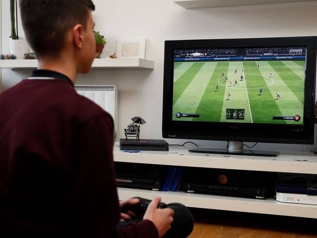 PARIS, FRANCE - DECEMBER 19: In this photo illustration a gamer plays the video game ‘FIFA 19&#039; developed and published by Electronic Arts (EA) on a Sony PlayStation game console PS4 Pro on December 19, 2018 in Paris, France. FIFA 19 is a soccer video game released on September 28, 2018. This is the twenty-sixth installment of the FIFA franchise developed by EA. (Photo Illustration by Chesnot/Getty Images)