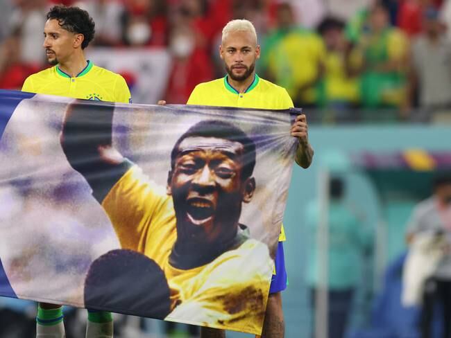 DOHA, QATAR - DECEMBER 05 Brazil&#039;s Neymar and Marquinhos hold a banner in support of former Brazil player Pele after the FIFA World Cup Qatar 2022 Round of 16 match between Brazil and South Korea at Stadium 974 on December 5, 2022 in Doha, Qatar. (Photo by Marc Atkins/Getty Images)