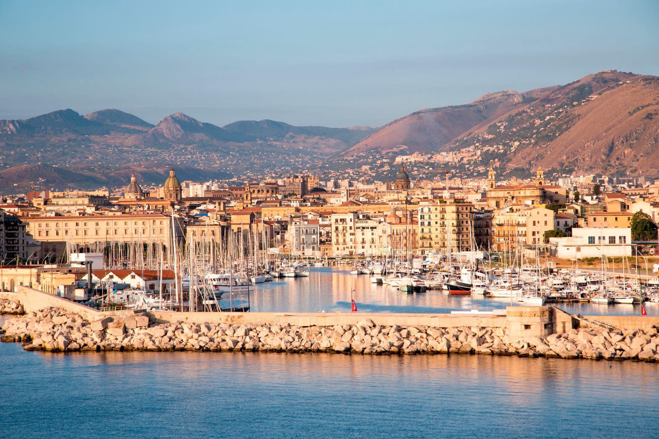 Breakwater, marina, city and mountains seen from sea, Palermo, Sicily, Italy.
