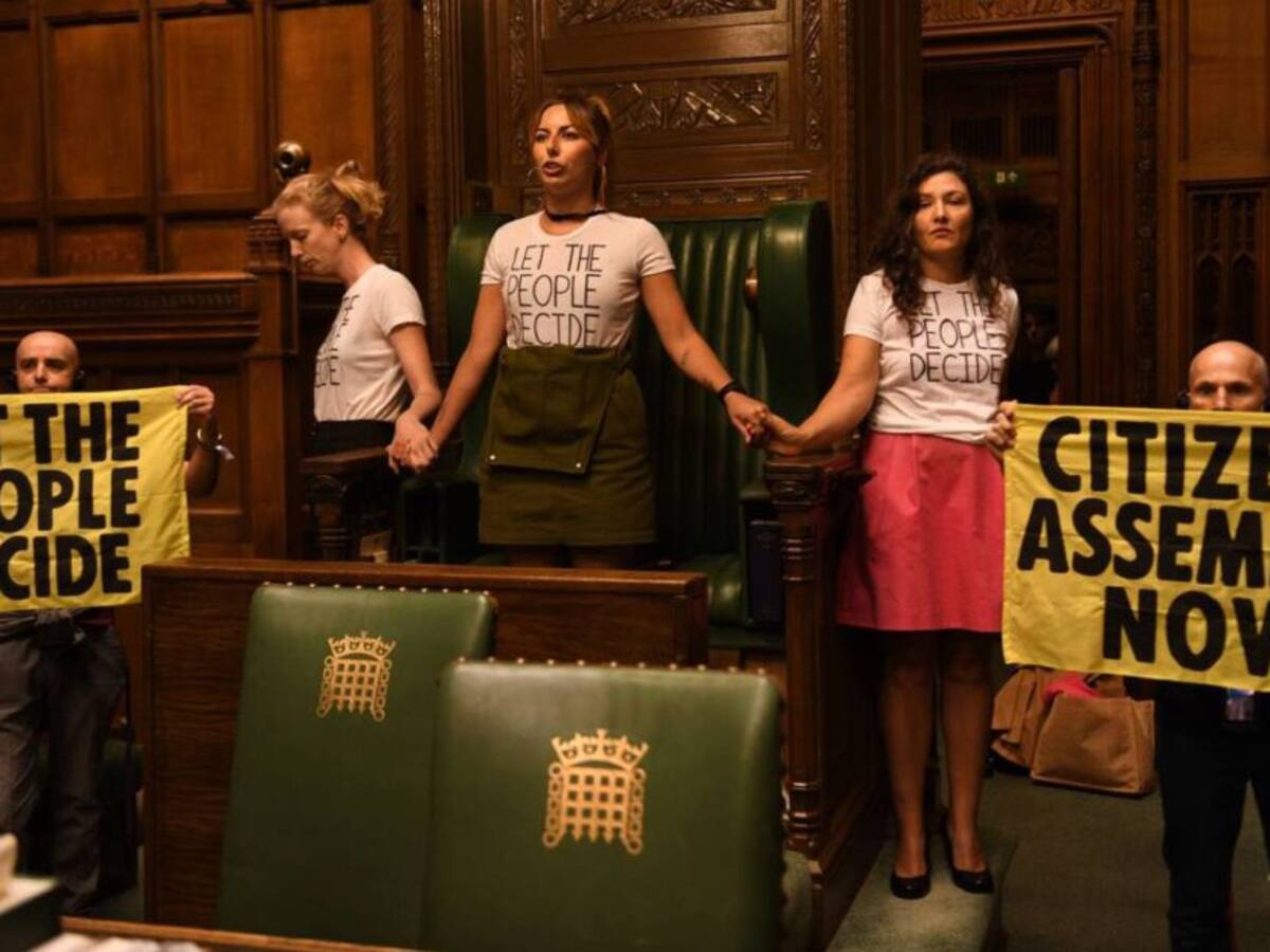 Activistas se pegan a las sillas del Parlamento británico en protesta
