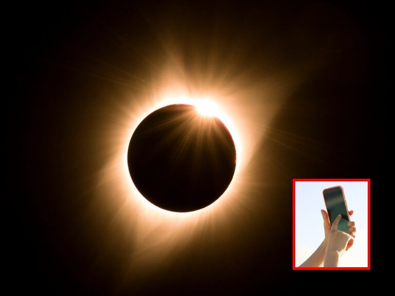 Imagen de referencia Eclipse solar y persona tomando foto con celular // Getty Images