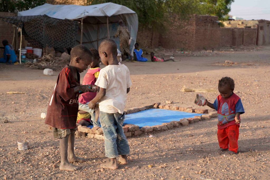 Internally displaced Sudanese children play outside while residing in the Hasahisa secondary school on July 10, 2023, transformed to house people fleeing violence in the war-torn country. Conflict-torn Sudan is on the brink of a "full-scale civil war" that could destabilise the entire region, the United Nations warned on July 9, after an air strike on a residential area killed around two dozen civilians. (Photo by AFP) (Photo by -/AFP via Getty Images)