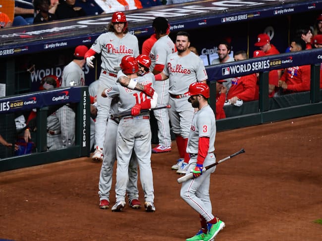 HOUSTON, TX - OCTOBER 28:   J.T. Realmuto #10 of the Philadelphia Phillies hugs Nick Castellanos #8 after hitting a home run in the tenth inning to take the lead during Game 1 of the 2022 World Series between the Philadelphia Phillies and the Houston Astros at Minute Maid Park on Friday, October 28, 2022 in Houston, Texas. (Photo by Logan Riely/MLB Photos via Getty Images)