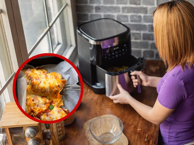Mujer usando una freidora de aire en la cocina // lasaña // Getty Images