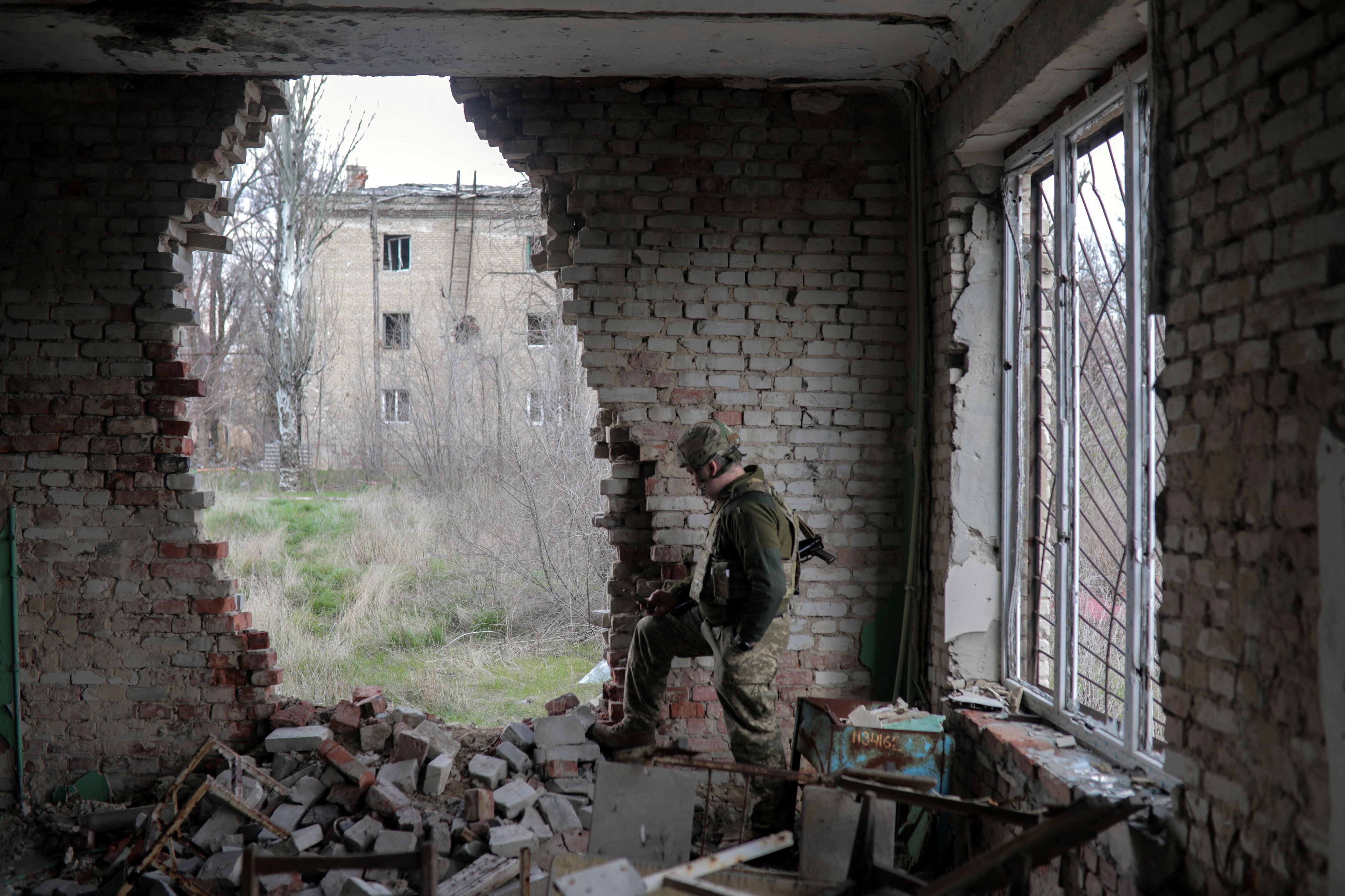 A Ukrainian serviceman stands near the front line with Russia backed separatists in the small town of Pisky, near Donetsk on April 21, 2021. - Ukraine's President Volodymyr Zelensky on April 20, 2021, invited Russian leader Vladimir Putin to meet in war-torn eastern Ukraine, stressing that millions of lives were at stake from fresh fighting in the separatist conflict. (Photo by Aleksey Filippov / AFP) (Photo by ALEKSEY FILIPPOV/AFP via Getty Images)