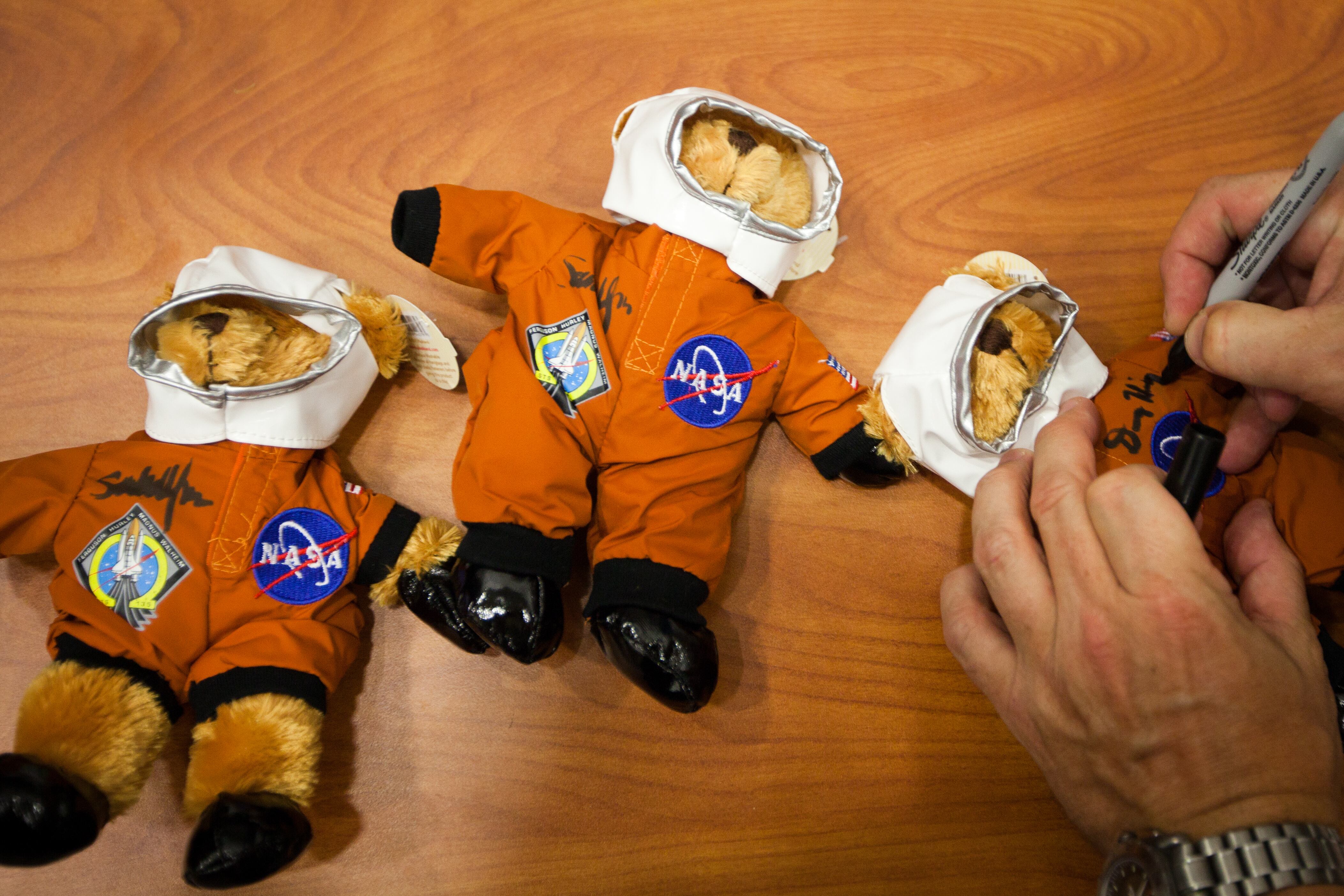 NASA astronaut Doug Hurley autographs commemorative teddy bears  for one of the crew's trainers after the crew of STS-135 trained in the Crew Compartment Trainer (CCT) II mockup at the Johnson Space Center  on Wednesday, June 29, 2011, in Houston. The training marked the crew's final scheduled in JSC Bldg. 9, the Space Vehicle Mockup Facility (SVMF). ( Smiley N. Pool / Houston Chronicle ) (Photo by Smiley N. Pool/Houston Chronicle via Getty Images)