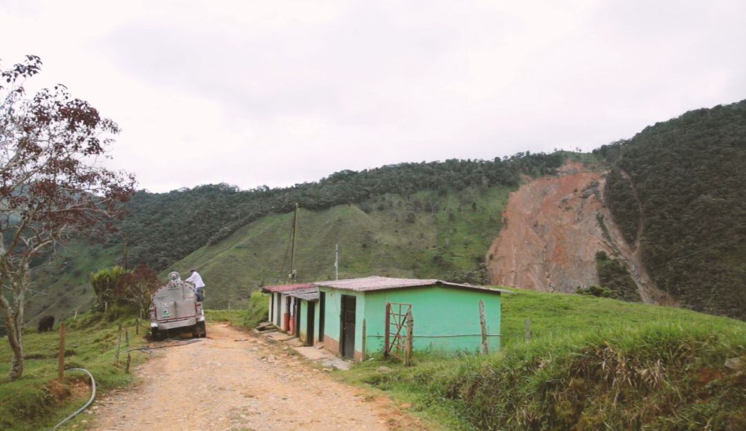 Con largas mangueras conectadas a los vehículos, recogen leche desde zona con vía bloqueadqa por alud