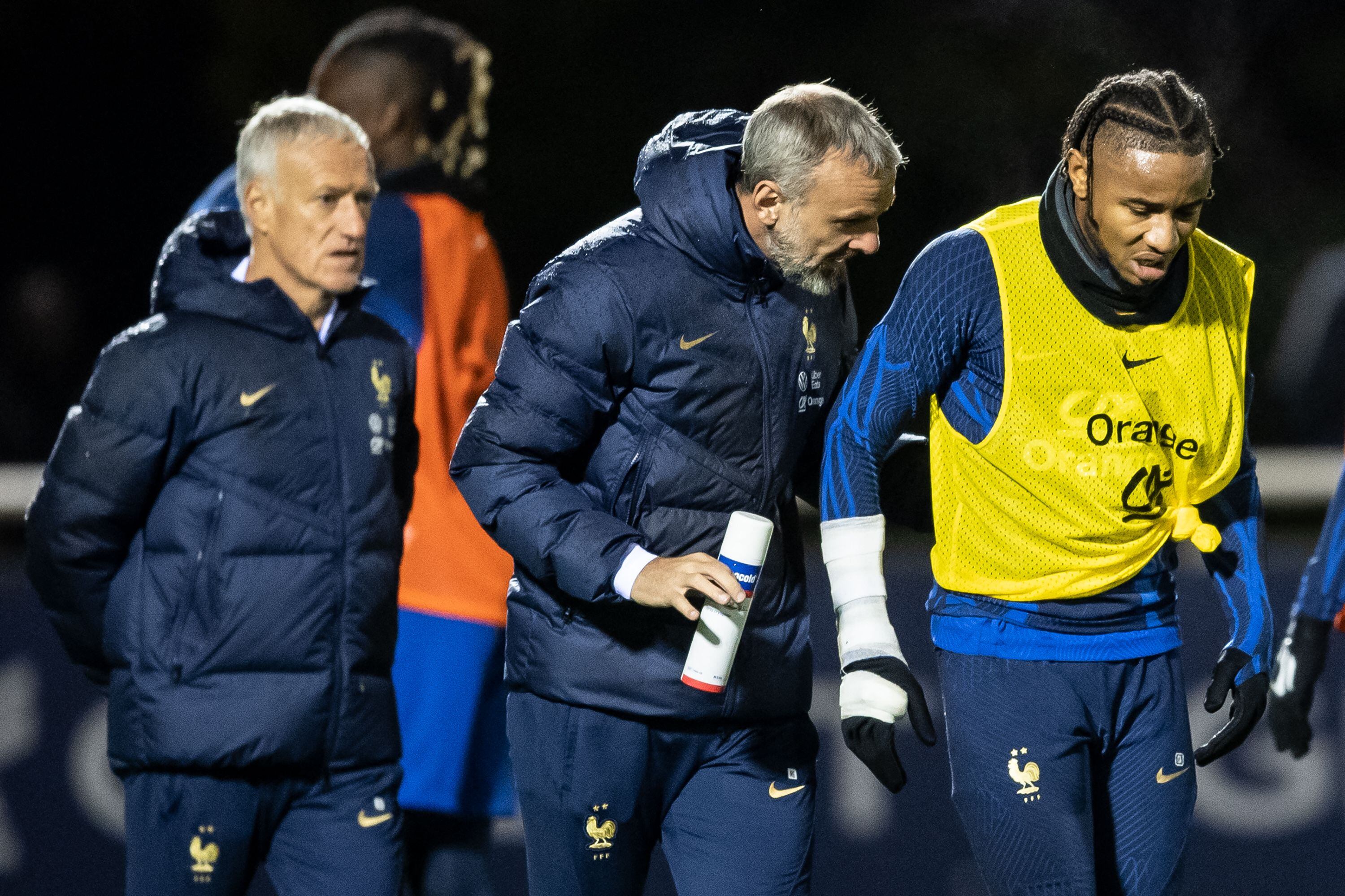 France's national football team forward Christopher Nkunku (R) reacts after being injured during a training session at the team's training camp in Clairefontaine-en-Yvelines, south of Paris, on November 15, 2022, five days ahead of the Qatar 2022 FIFA World Cup football tournament. (Photo by BERTRAND GUAY / AFP) (Photo by BERTRAND GUAY/AFP via Getty Images)