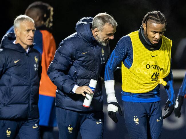 France's national football team forward Christopher Nkunku (R) reacts after being injured during a training session at the team's training camp in Clairefontaine-en-Yvelines, south of Paris, on November 15, 2022, five days ahead of the Qatar 2022 FIFA World Cup football tournament. (Photo by BERTRAND GUAY / AFP) (Photo by BERTRAND GUAY/AFP via Getty Images)