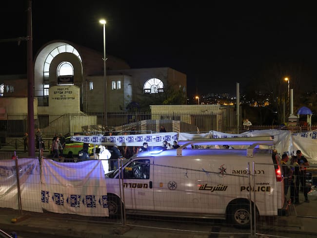 EDITORS NOTE: Graphic content / Israeli emergency service personnel close-off the site of a reported attack at a synagogue in a settler neighbourhood of Israeli-annexed east Jerusalem, on January 27, 2023. (Photo by RONALDO SCHEMIDT / AFP) (Photo by RONALDO SCHEMIDT/AFP via Getty Images)