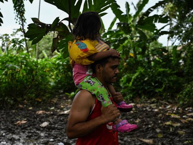Venezuelan migrants arrive at Canaan Membrillo village, tthe first border control of the Darien Province in Panama. - The clandestine journey through the Darien Gap usually lasts five or six days at the mercy of all kinds of bad weather: snakes, swamps and drug traffickers who use these routes to take cocaine to Central America. - TO GO WITH AFP STORY BY JUAN JOSE RODRIGUEZ (Photo by Luis ACOSTA / AFP) / TO GO WITH AFP STORY BY JUAN JOSE RODRIGUEZ (Photo by LUIS ACOSTA/AFP via Getty Images)