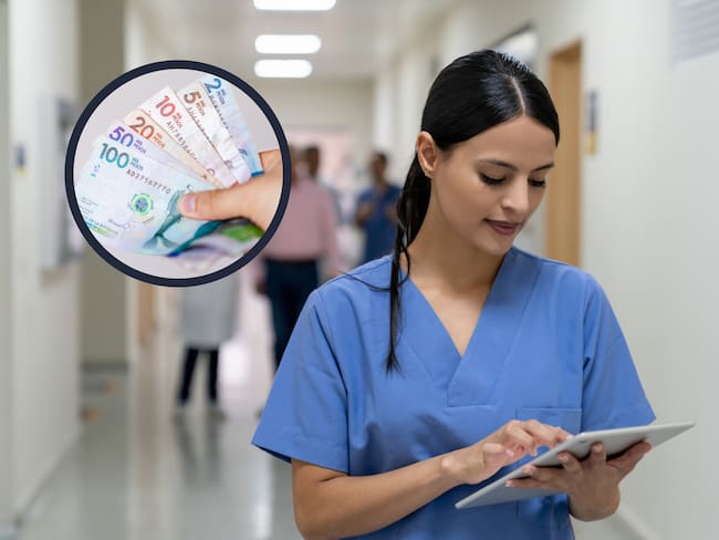 Enfermera mirando hacía su Tablet en el pasillo de un hospital (Foto vía Getty Images)