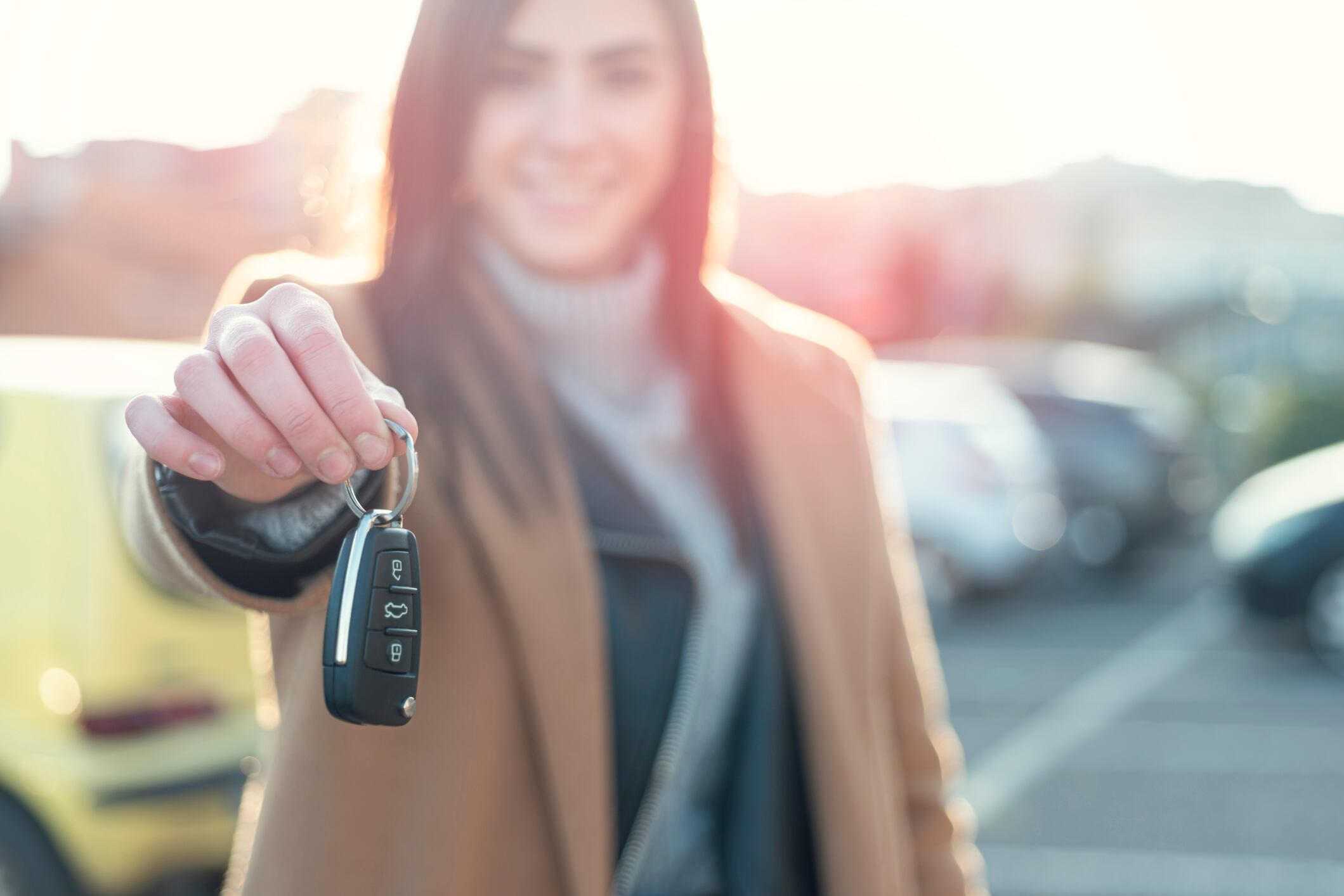 Smiling Young woman Holding Car Key