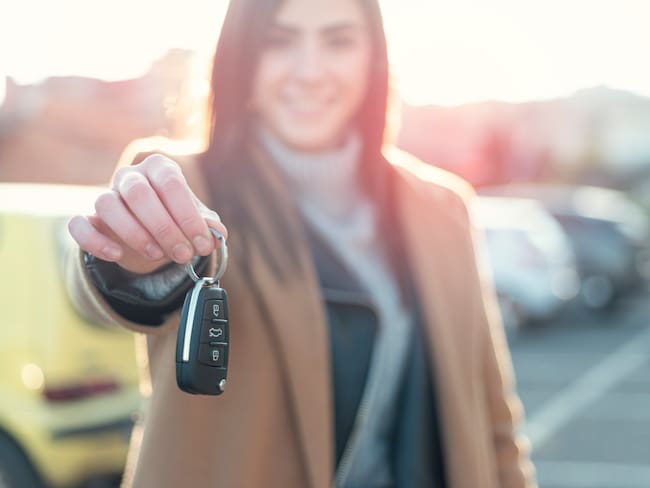 Smiling Young woman Holding Car Key