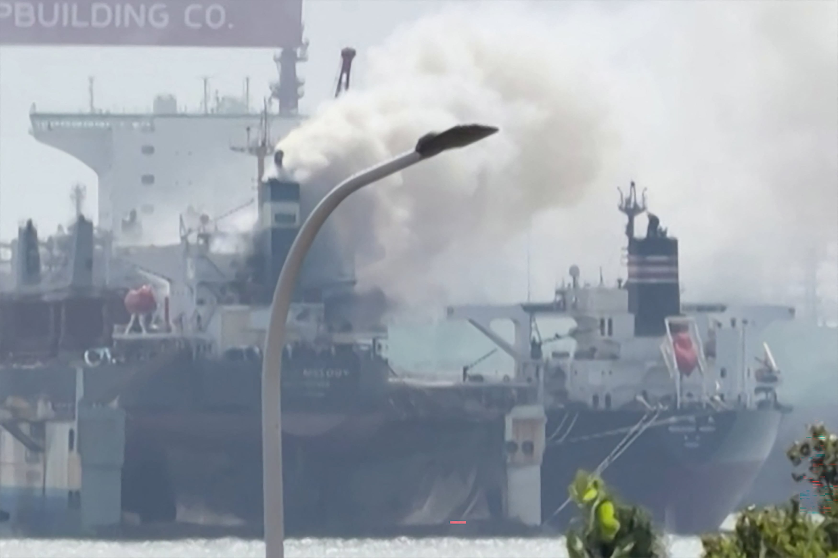 This screengrab from video taken on September 10, 2026 and provided by Qingdao WoLin Packaging shows smoke rising from a cargo ship at a port in Qingdao in eastern China. A fire erupted September 10 on a foreign-flagged cargo ship docked in an Chinese port, leaving at least 20 people dead and five missing, state media said. (Photo by Qingdao WoLin Packaging / AFP) / RESTRICTED TO EDITORIAL USE � MANDATORY CREDIT �  AFP PHOTO / Qingdao WoLin Packaging � - NO MARKETING NO ADVERTISING CAMPAIGNS � DISTRIBUTED AS A SERVICE TO CLIENTS - NO ARCHIVE