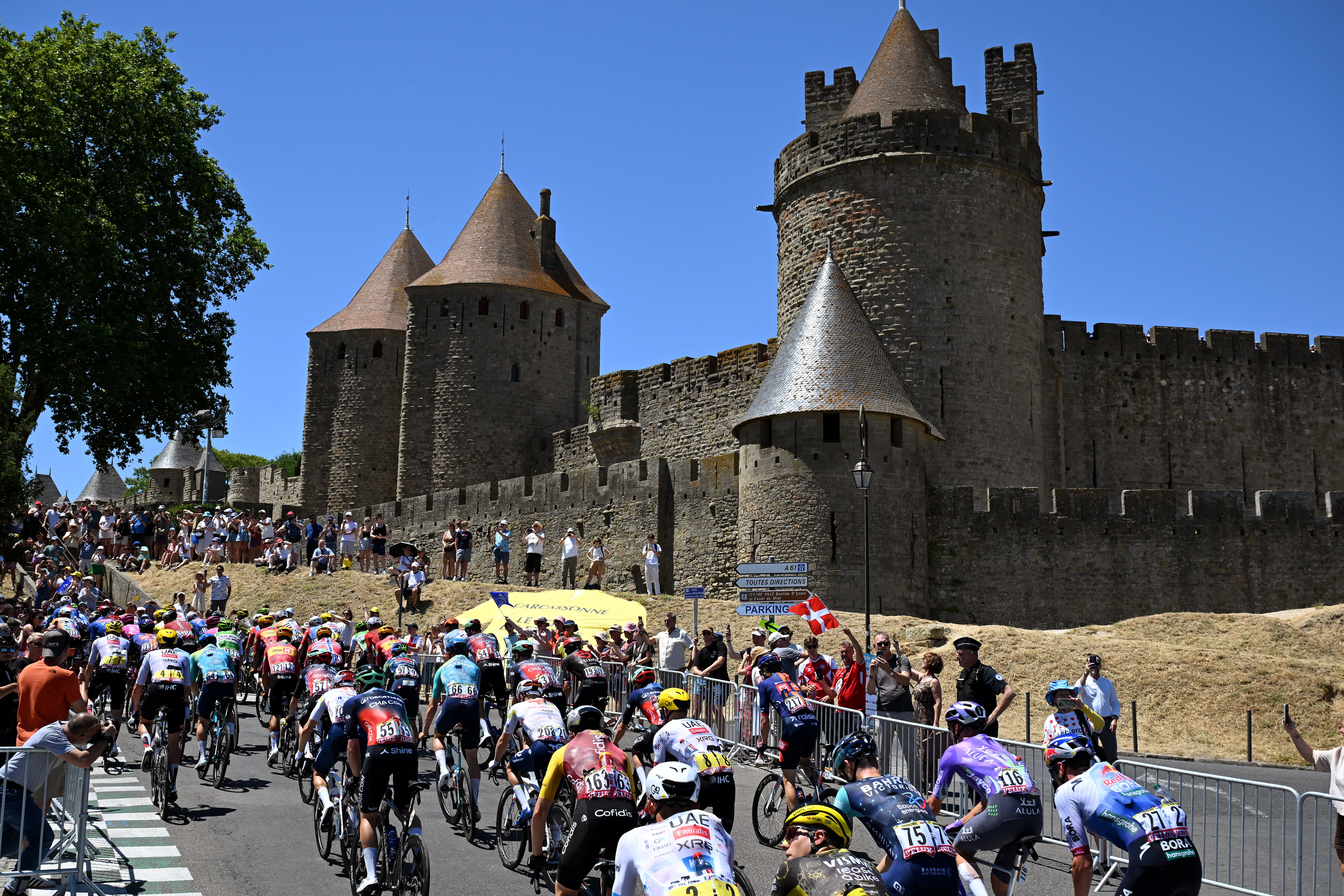 CARCASSONNE, FRANCE - JULY 07: A general view of the peloton passing close to the Carcassonne City-walls prior to the 113th Tour de France 2026, Stage 4 a 181.9km stage from Carcassonne to Foix / #UCIWT / on July 07, 2026 in Carcassonne, France. (Photo by Tim de Waele/Getty Images)