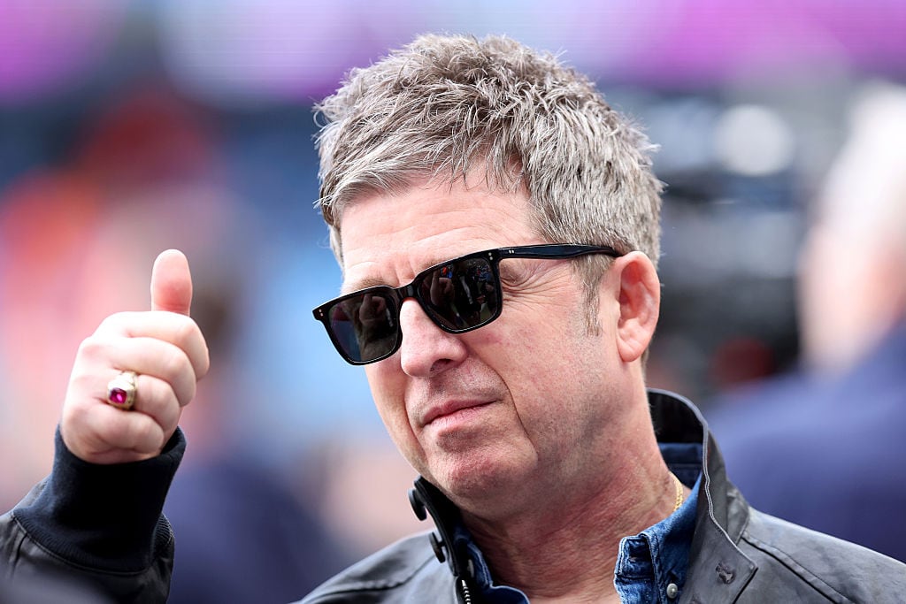 MANCHESTER, ENGLAND - APRIL 19: Musician, singer and songwriter Noel Gallagher gives a thumbs up before the Premier League match between Manchester City and Arsenal at Etihad Stadium on April 19, 2026 in Manchester, England. (Photo by Copa/Getty Images)
