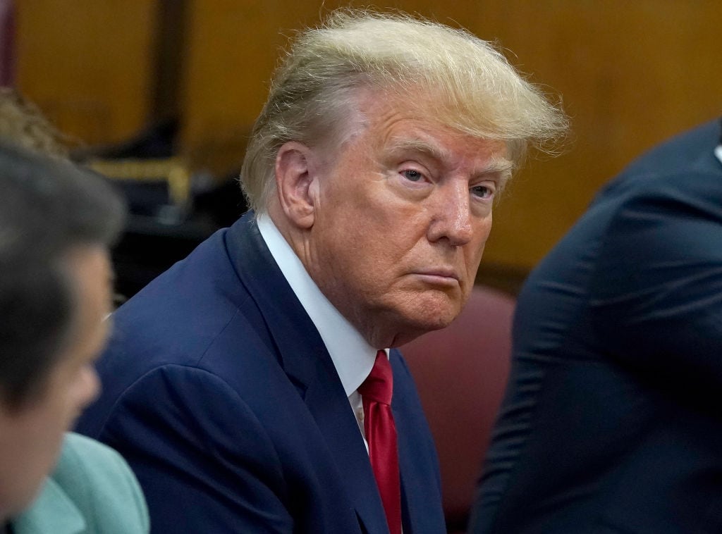 NEW YORK, NY - APRIL 04:  Former U.S. President Donald Trump sits with his attorneys inside the courtroom during his arraignment at the Manhattan Criminal Court April 4, 2023 in New York City. Trump pleaded not guilty to 34 felony counts stemming from hush money payments made to adult film star Stormy Daniels before the 2016 presidential election. With his indictment, Trump will become the first former U.S. president in history to be charged with a criminal offense. (Photo by Timothy A. Clary-Pool/Getty Images)