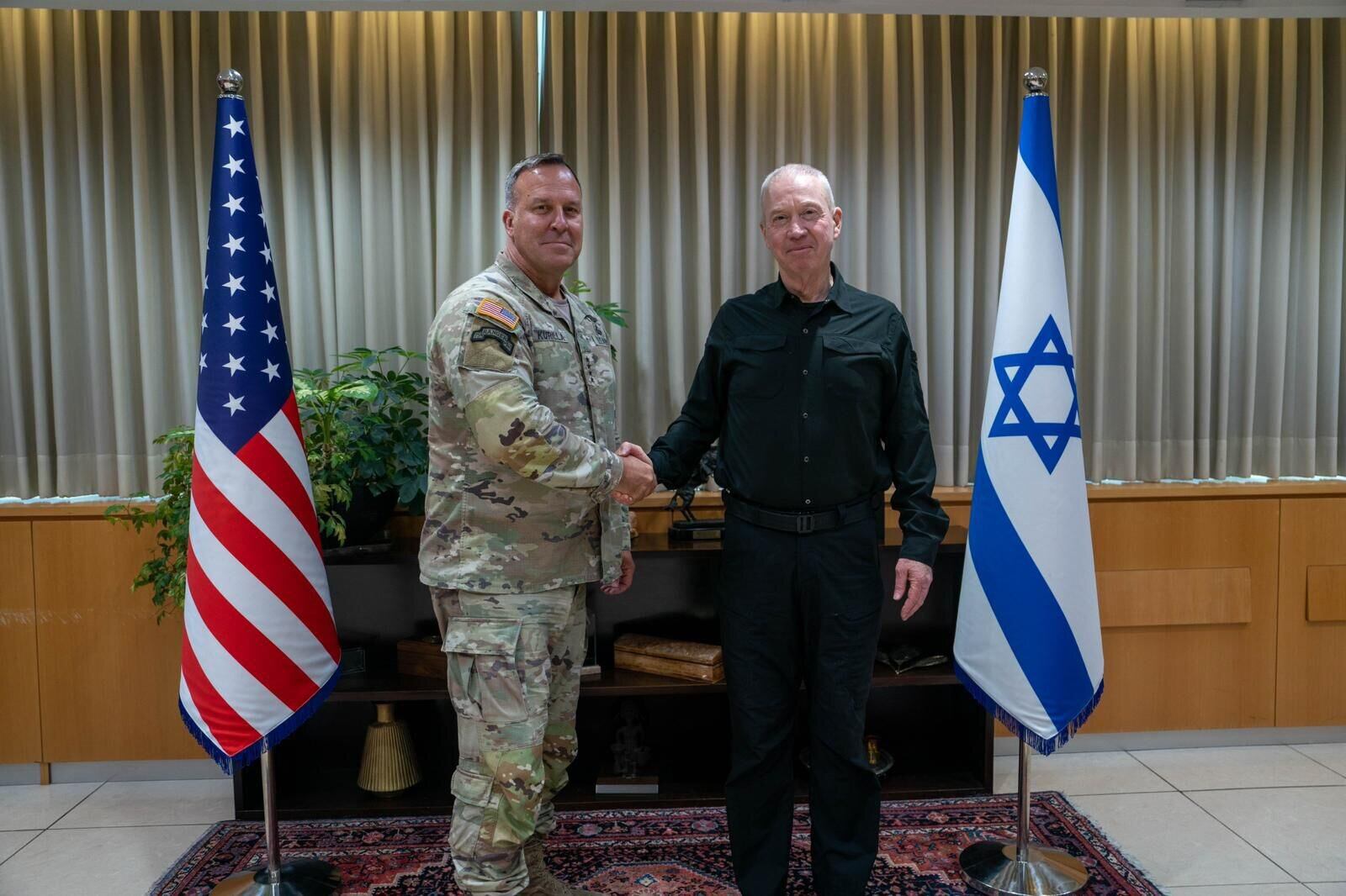 TEL AVIV, ISRAEL - AUGUST 05: (----EDITORIAL USE ONLY - MANDATORY CREDIT - 'ARIEL HERMONI / IMOD / HANDOUT' - NO MARKETING NO ADVERTISING CAMPAIGNS - DISTRIBUTED AS A SERVICE TO CLIENTS----) Israeli Defense Minister Yoav Gallant (R) and Commander of United States Central Command (CENTCOM) Michael Erik Kurilla (L) shakes hands as they meet in Tel Aviv, Israel on August 5, 2024. (Photo by Ariel Hermoni (IMoD) / Handout/Anadolu via Getty Images)