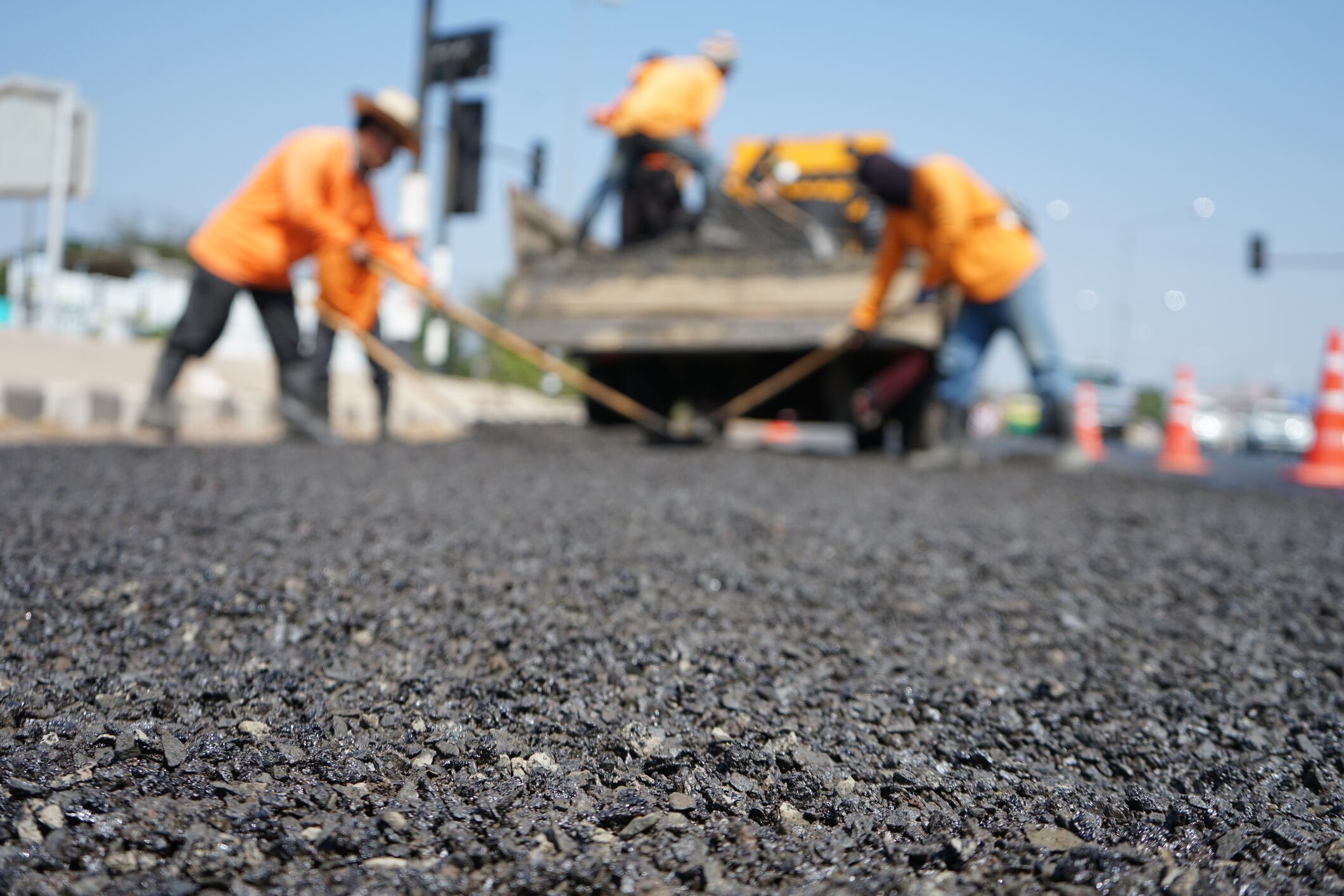 Blur image, repairing pavement mainly by manual labor