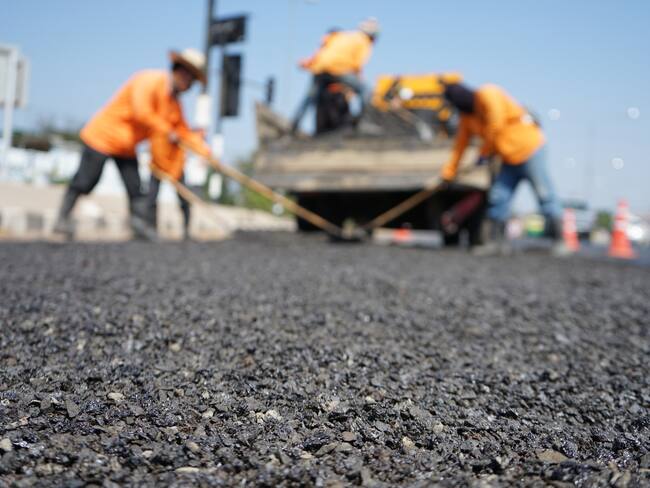 Blur image, repairing pavement mainly by manual labor