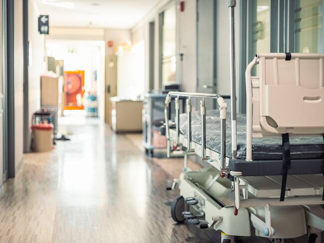 Empty hospital beds in hospital corridor