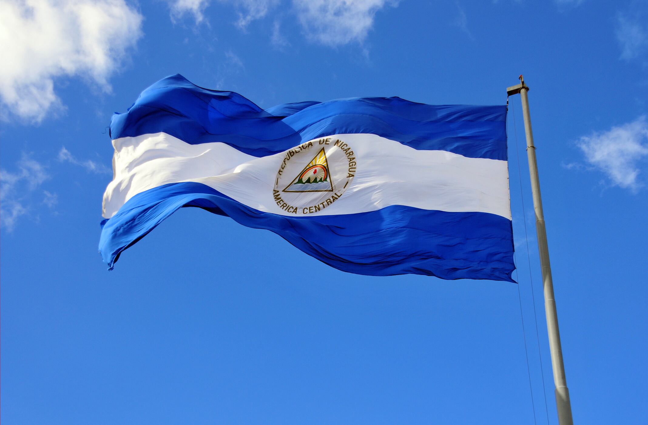 Nicaraguan flag waving in the wind at Plaza de la Revolución / Plaza de la República, Managua