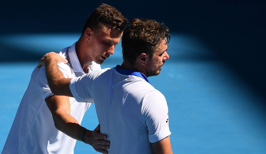 Wawrinka felicita a Fucsovics tras la épica remontada.