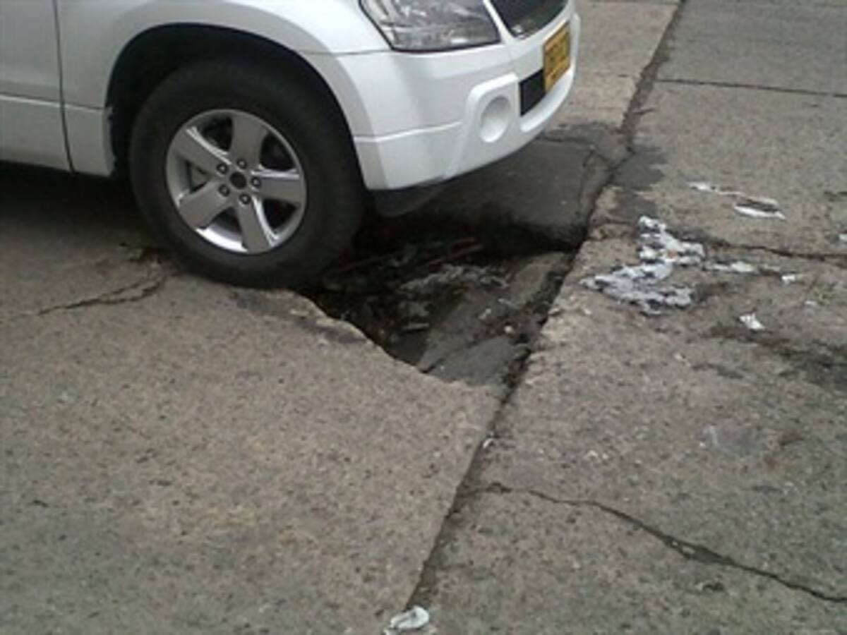 Diariamente cinco vehículos se dañan por gigantesco hueco en Bogotá