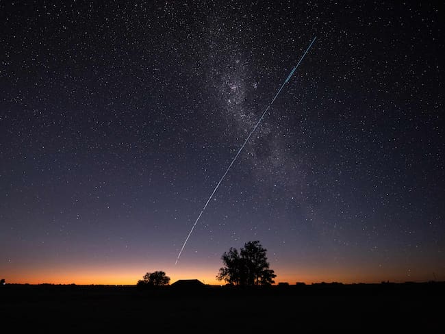 TOPSHOT - This long-exposure image shows a trail of a group of SpaceX&#039;s Starlink G6-27 satellites passing over Uruguay, with part of the Milky Way and planet Venus (L) in the frame, as seen from the countryside some 185 km north of Montevideo near Capilla del Sauce, Florida Department, at twilight early on November 12, 2023. (Photo by Mariana SUAREZ / AFP) (Photo by MARIANA SUAREZ/AFP via Getty Images)