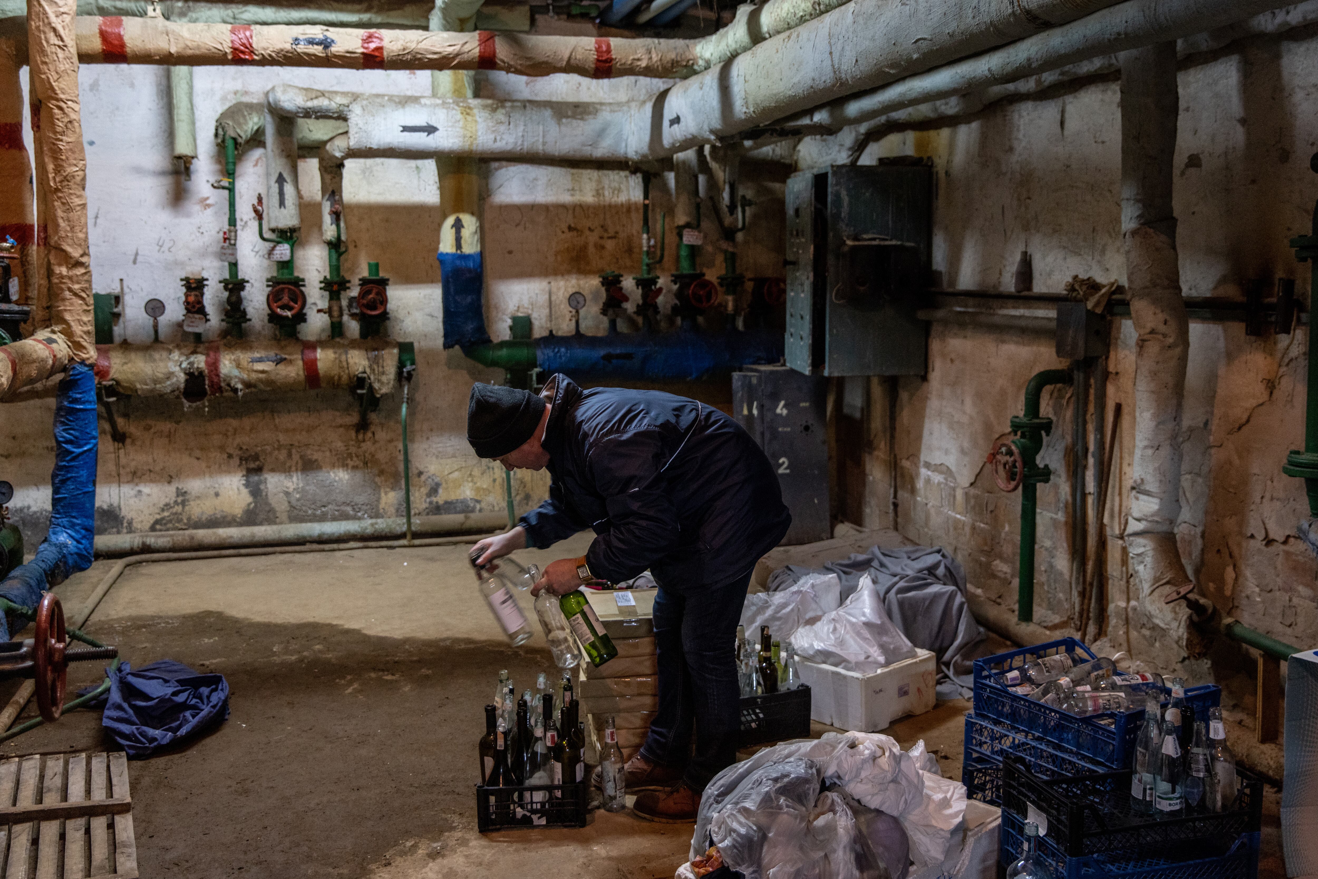 KYIV, UKRAINE - FEBRUARY 26: A man stacks bottles to make molotov cocktails in the basement of a bomb shelter on February 26, 2022 in Kyiv, Ukraine. Explosions and gunfire were reported around Kyiv on the second night of Russia's invasion of Ukraine, which has killed scores and prompted widespread condemnation from US and European leaders. (Photo by Chris McGrath/Getty Images)