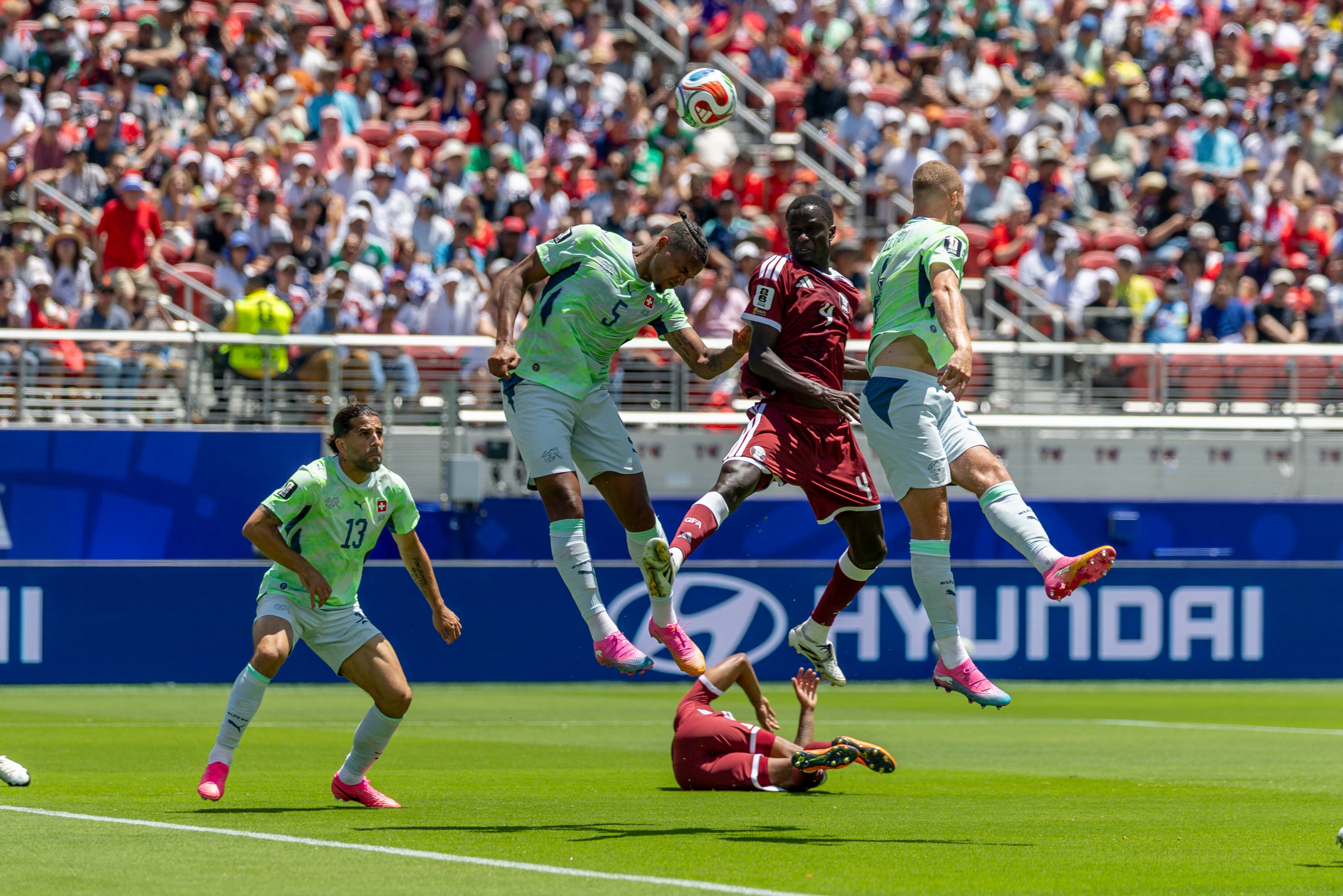 SANTA CLARA, CA - JUNE 13: Issa Laye #4 of Qatar tries to steer the ball toward the goal during the first half of the FIFA World Cup 2026 Group B match between Qatar and Switzerland on June 13, 2026 at the San Francisco Bay Area Stadium in Santa Clara, CA. (Photo by Bob Kupbens/Icon Sportswire via Getty Images)