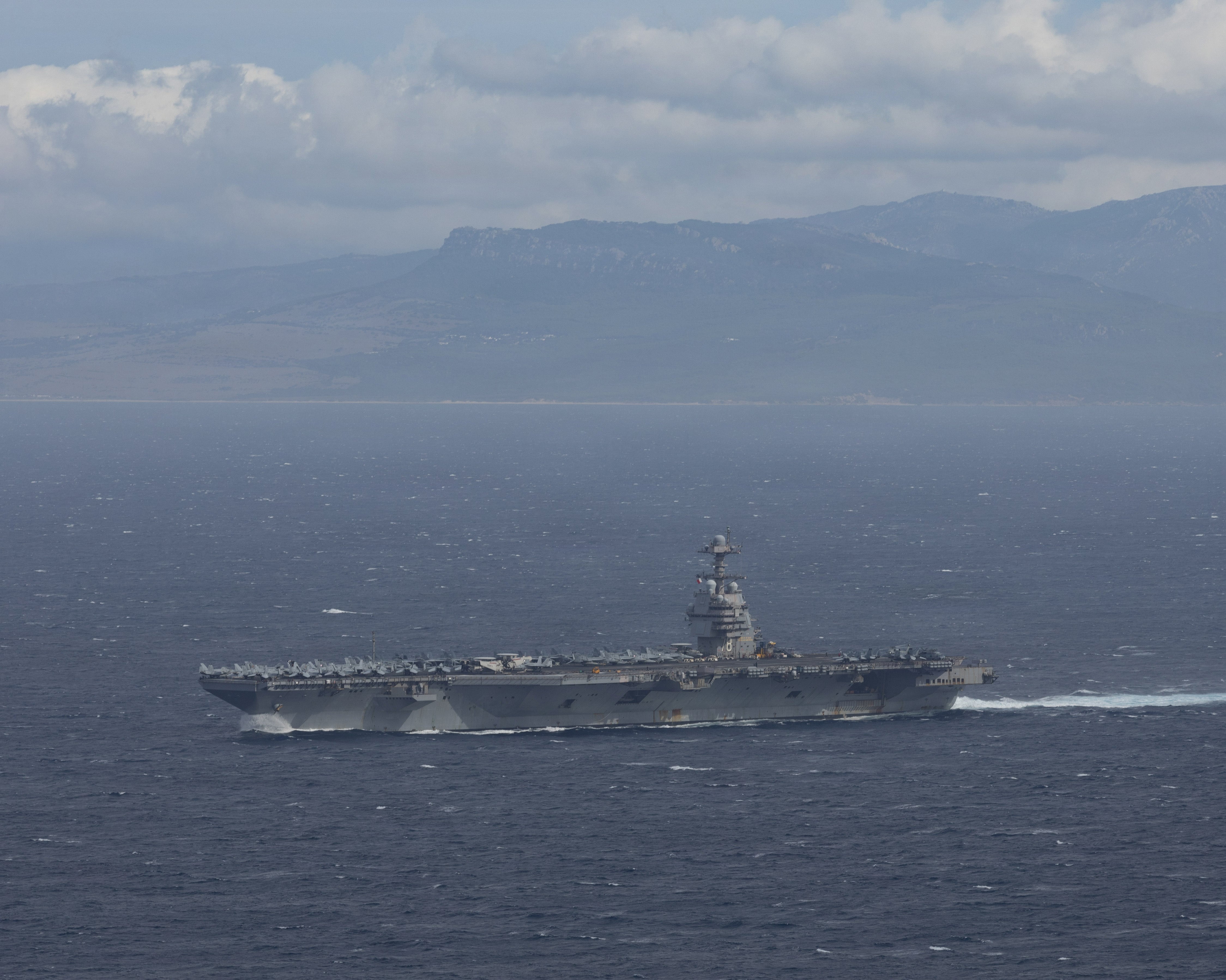 The world's largest aircraft carrier, USS Gerald R. Ford (CVN 78), transits the Strait of Gibraltar, Nov. 4, 2025. Gerald R. Ford, a first-in-class aircraft carrier and deployed flagship of Carrier Strike Group 12, is on a scheduled deployment in the U.S. 6th Fleet area of operations to support the warfighting effectiveness, lethality and readiness of U.S. Naval Forces Europe-Africa, and defend U.S., Allied and partner interests in the region. (U.S. Navy photo by Mass Communication Specialist 2nd Class Triniti Lersch)