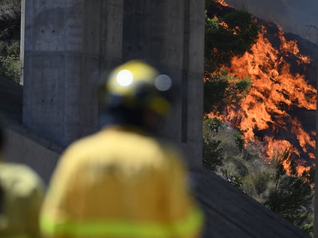 Firefighters of the Infoca (Andalusia Wildfire Service) monitor a fire in the area of a wildfire that killed 11 near Bedar, in Los Gallardos district, in Almeria Province, on July 10, 2026. Eleven people were killed and 19 are missing after a wildfire tore through a Spanish village, with four victims who may have been British who were burned in their car, authorities said. (Photo by JOSE JORDAN / AFP)
