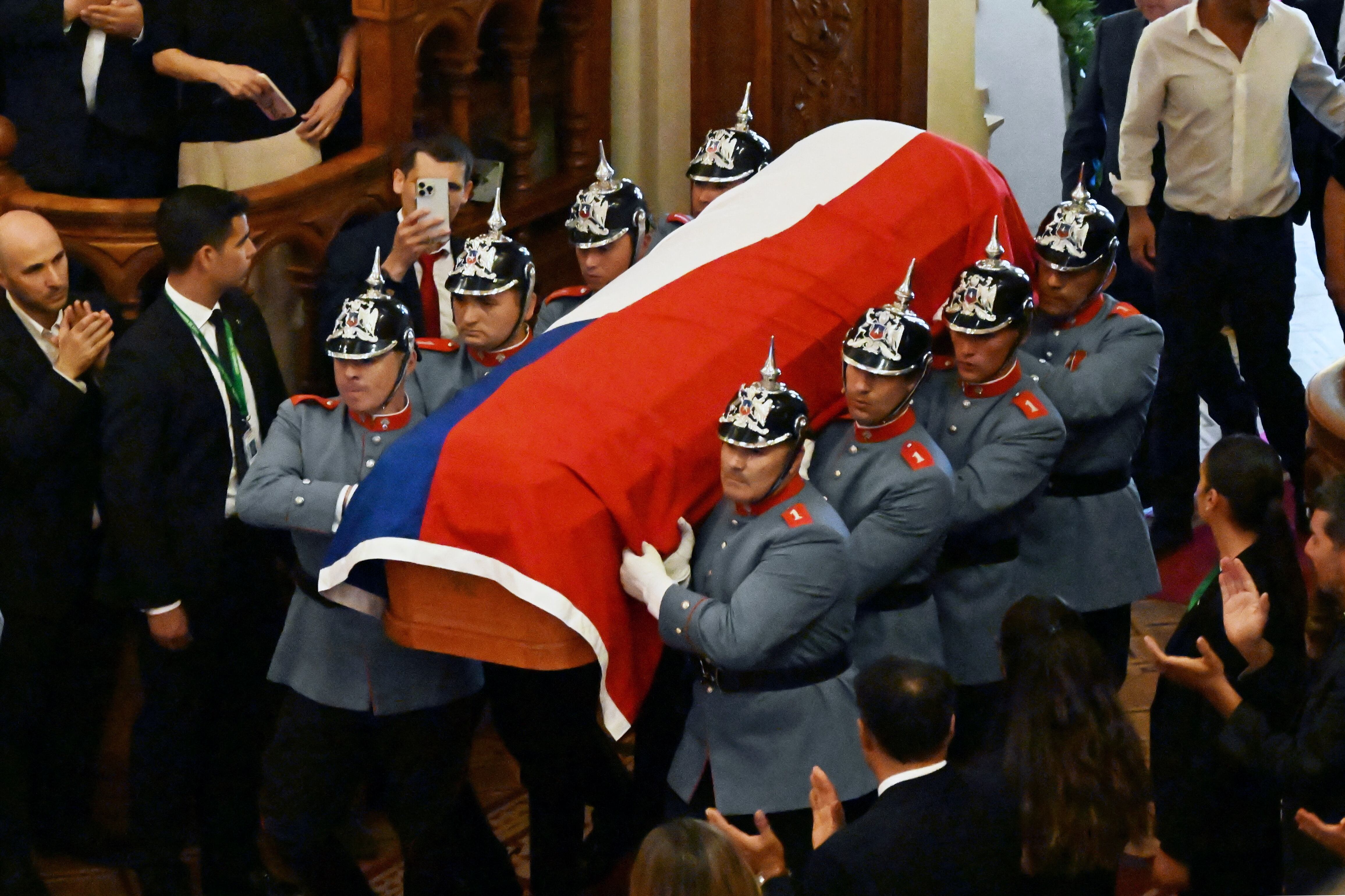 Three days of mourning and funeral ceremonies got underway Wednesday for Chile's ex-president Sebastian Pinera, who died a day earlier when the helicopter he was piloting crashed into a lake. (Photo by RODRIGO ARANGUA / AFP)