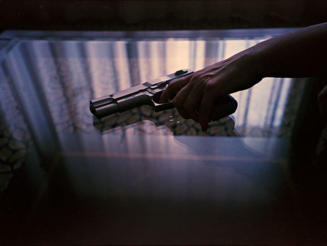 Spy thriller book cover design with man holding pistol gun.