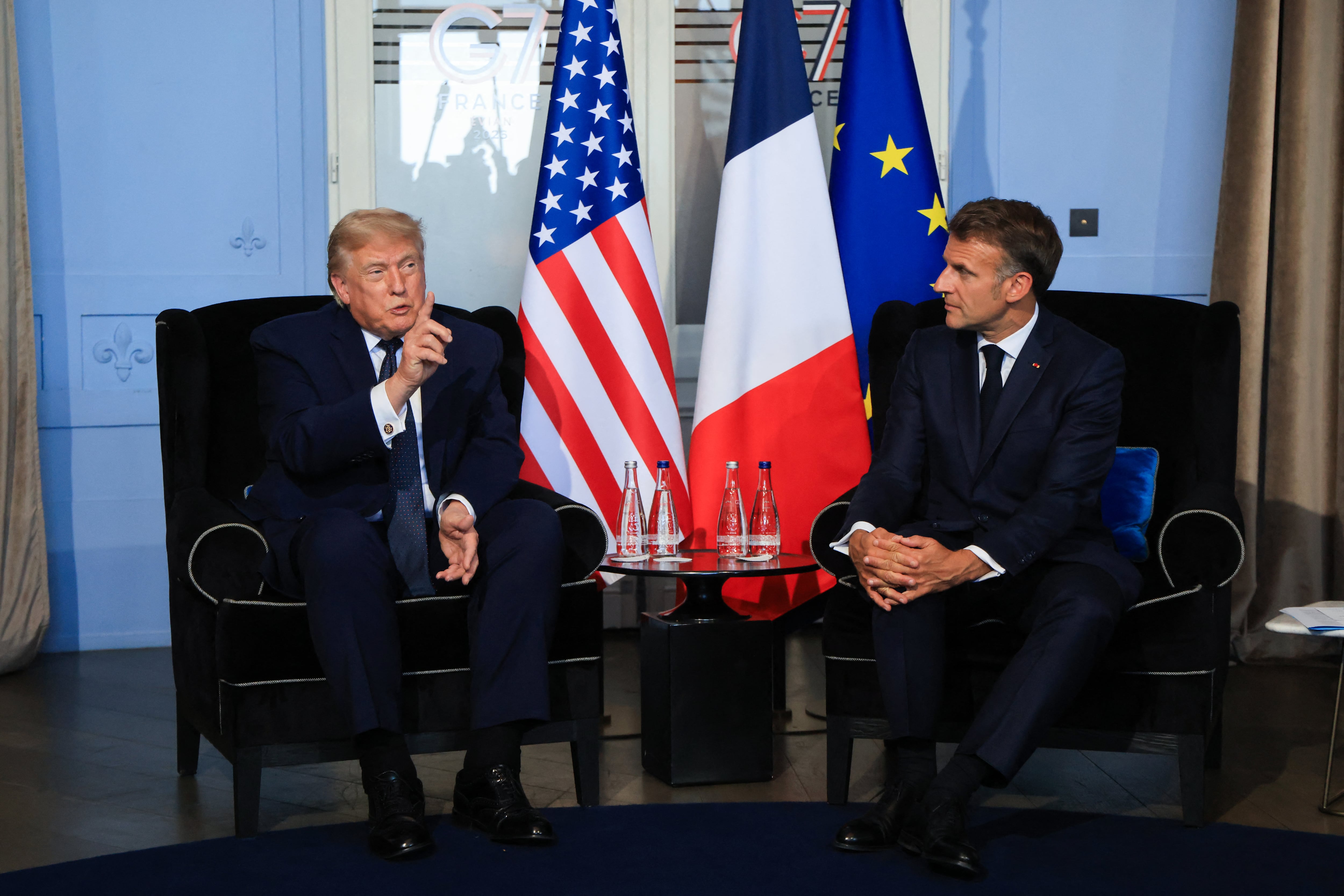 US President Donald Trump (L) attends a bilateral meeting with France's President Emmanuel Macron on the sidelines of the G7 summit, in Evian, central-eastern France on June 15, 2026. A G7 summit is set to take place June 15 to 17 in the French town of Evian-les-Bains near Switzerland and it will be attended by country leaders as well as the EU's foreign policy chief and ministers from Brazil, Canada, the United Arab Emirates and Turkey. (Photo by Ludovic MARIN / POOL / AFP)