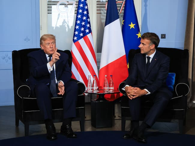 US President Donald Trump (L) attends a bilateral meeting with France's President Emmanuel Macron on the sidelines of the G7 summit, in Evian, central-eastern France on June 15, 2026. A G7 summit is set to take place June 15 to 17 in the French town of Evian-les-Bains near Switzerland and it will be attended by country leaders as well as the EU's foreign policy chief and ministers from Brazil, Canada, the United Arab Emirates and Turkey. (Photo by Ludovic MARIN / POOL / AFP)