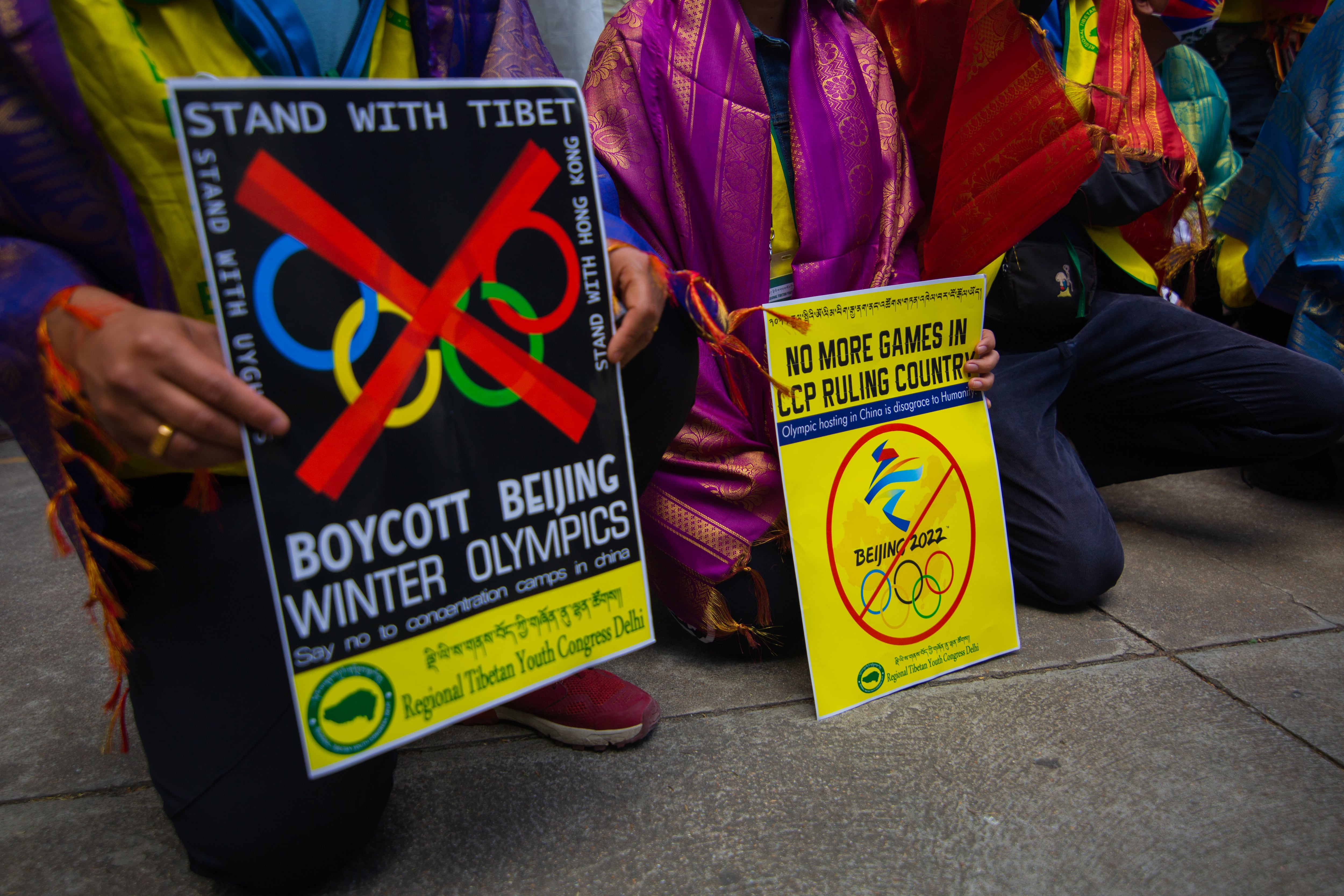 BENGALURU, INDIA - DECEMBER 10: Tibetan students hol placards calling for the boycott of the 2022 Beijing Winter Olympics during a protest on December 10, 2021 in Bengaluru, India. The lead up to the 2022 Beijing Winter Olympics is fraught with delicate political manoeuvrings with leading western nations calling for a diplomatic boycott of the games due to China’s alleged human rights abuse and repression of the predominantly Muslim Uyghur minority in the western region of Xinjiang. (Photo by Abhishek Chinnappa/Getty Images)