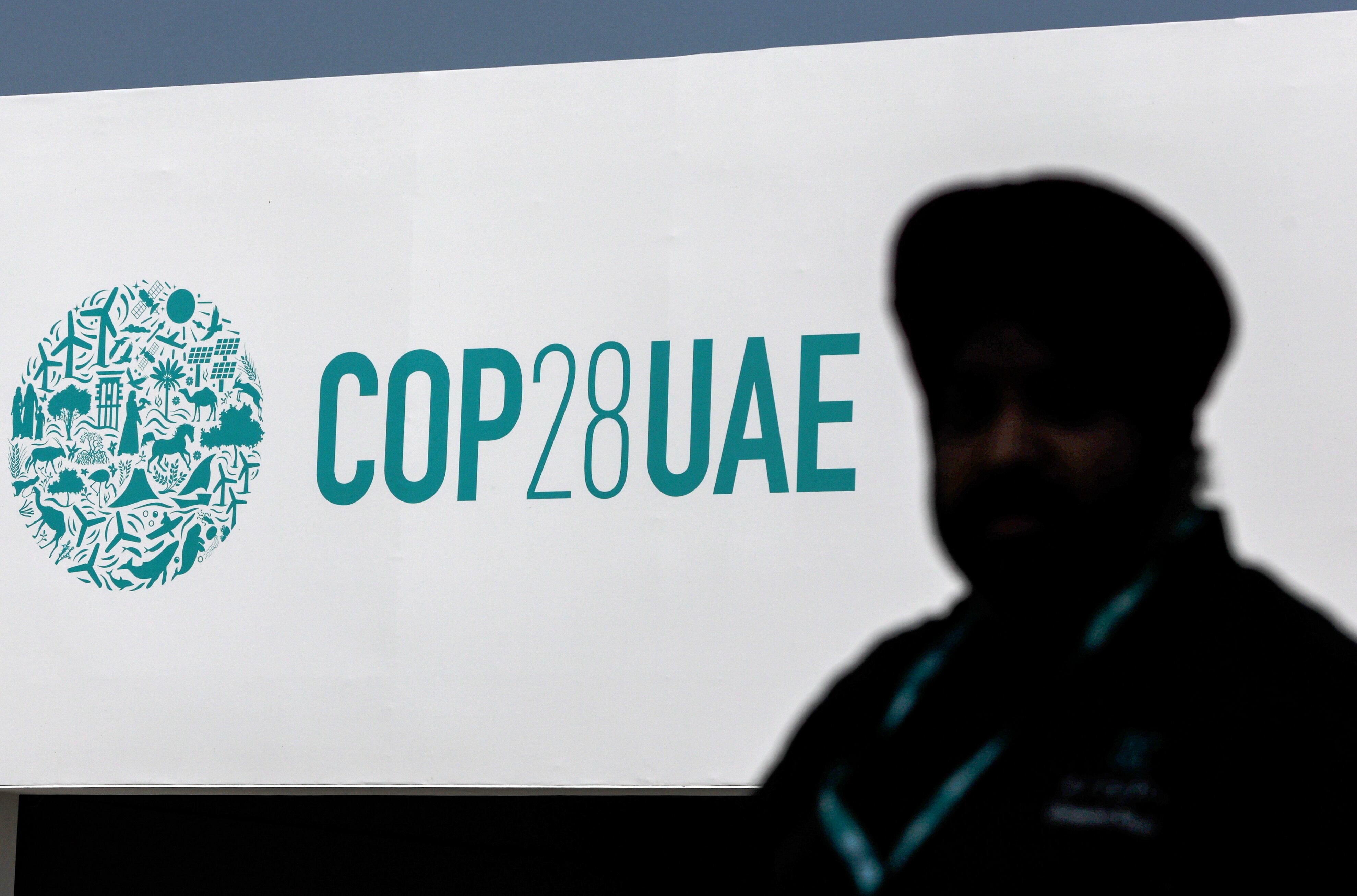 Dubai (United Arab Emirates), 29/11/2023.- A man walks in front of the COP28 logo at Expo City Dubai, the venue of the 2023 United Nations Climate Change Conference (COP28), in Dubai, UAE, 29 November 2023. The 2023 United Nations Climate Change Conference (COP28), runs from 30 November to 12 December, and is expected to host one of the largest number of participants in the annual global climate conference as over 70,000 estimated attendees, including the member states of the UN Framework Convention on Climate Change (UNFCCC), business leaders, young people, climate scientists, Indigenous Peoples and other relevant stakeholders will attend. EFE/EPA/ALI HAIDER