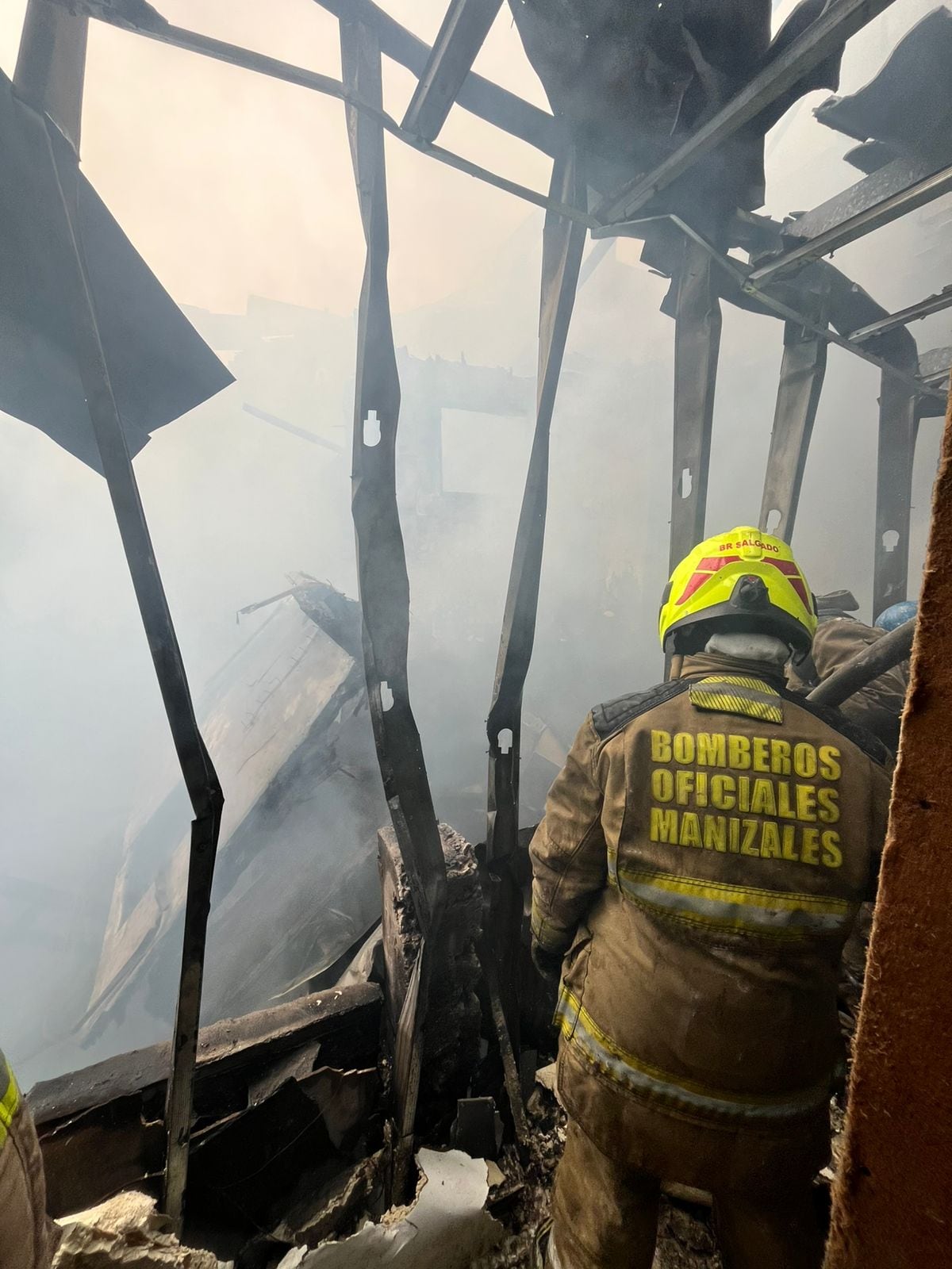 Un integrante de bomberos atendiendo la emergencia por un incendio en el barrio La Asunción. Foto: Unidad de Gestión del Riesgo de Manizales.